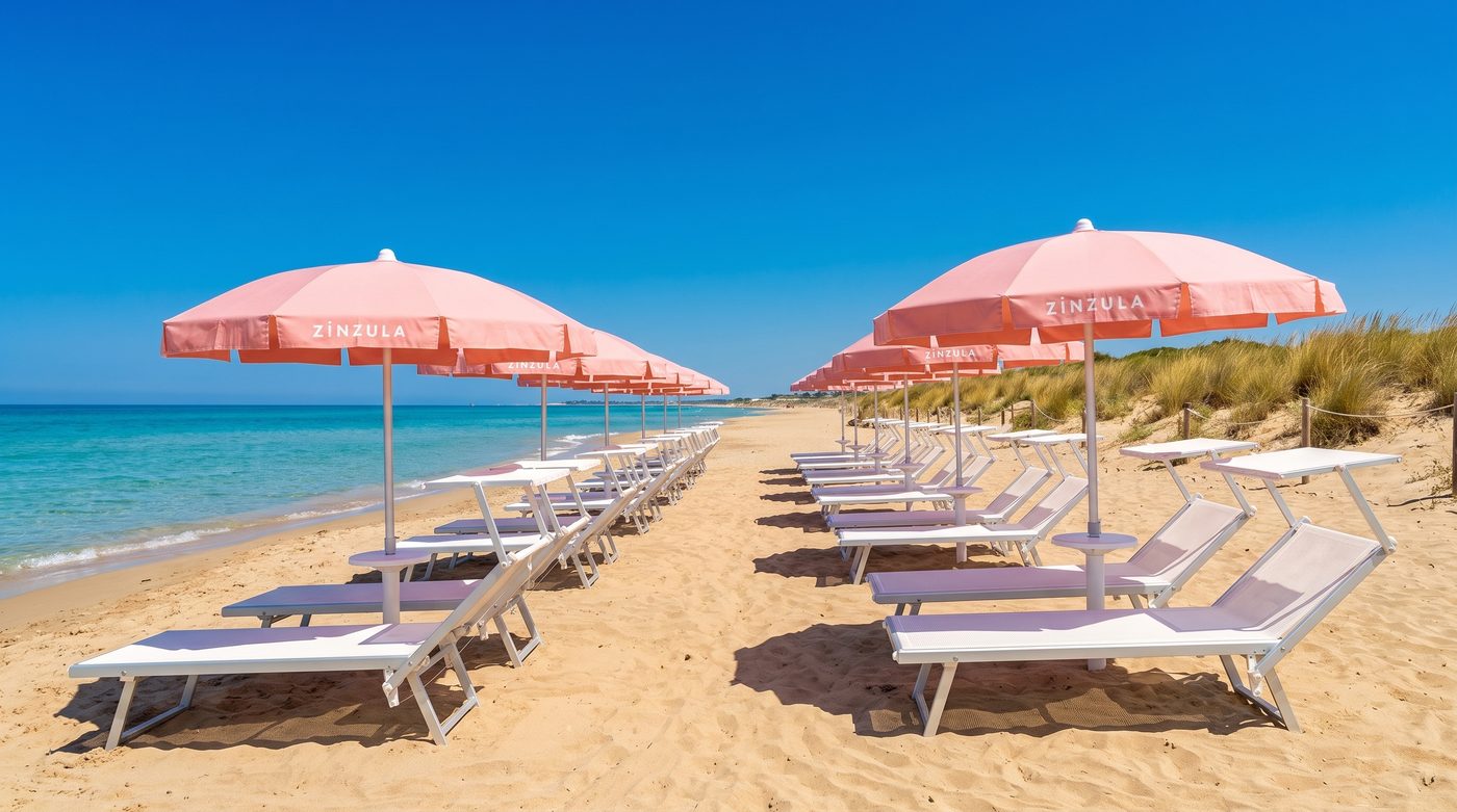 C Beach sunbeds and pink Zinzula umbrellas by the sea